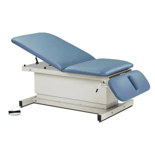 Blue examination table with footer on a white background