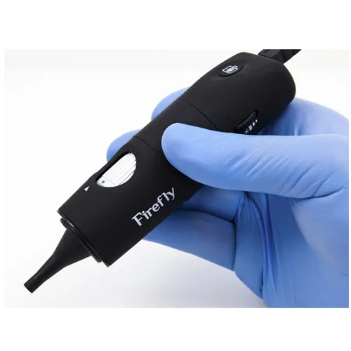 Black device labeled 'Firefly' held in a blue gloved hand against a white background