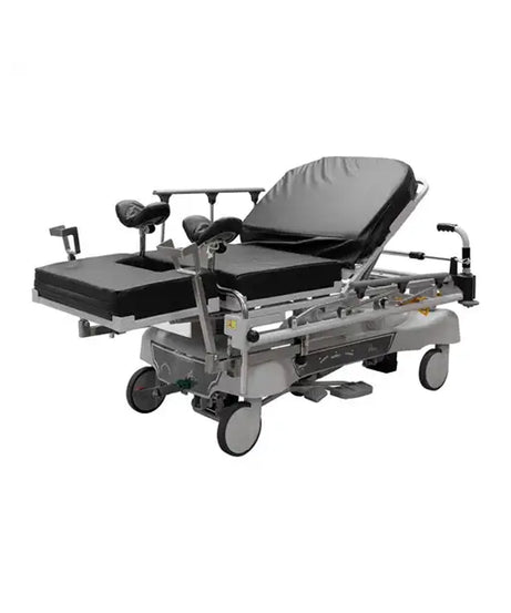 A medical gurney hospital bed with adjustable silver metal frame, black padded mattress sections, and four caster wheels, shown on a plain white background.