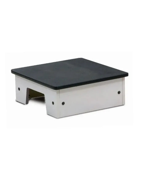 A small platform riser or step stool with a black top surface and a white metal frame, shown on a plain white background.