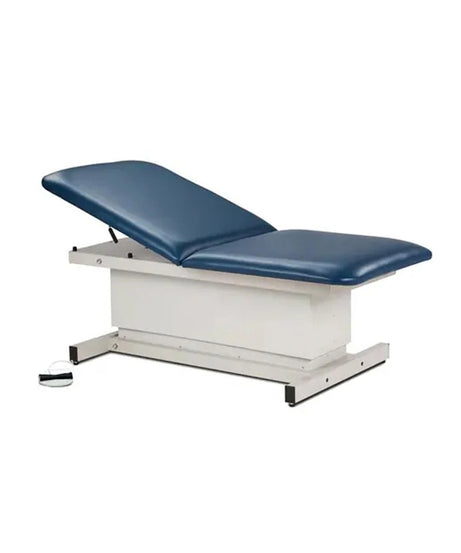 An adjustable medical examination table with a dark blue padded top and a white metal base, shown on a plain white background.