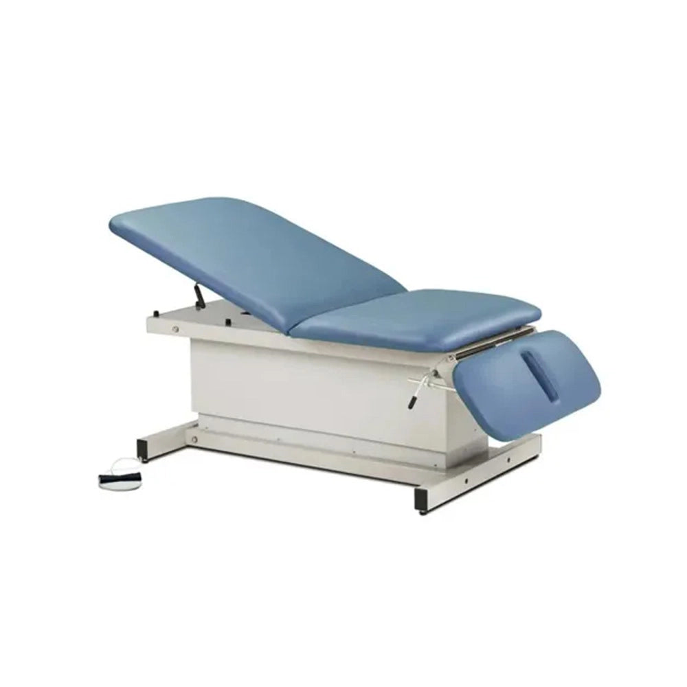 An adjustable medical examination table with blue padded surfaces and a white metal frame, shown on a plain white background.