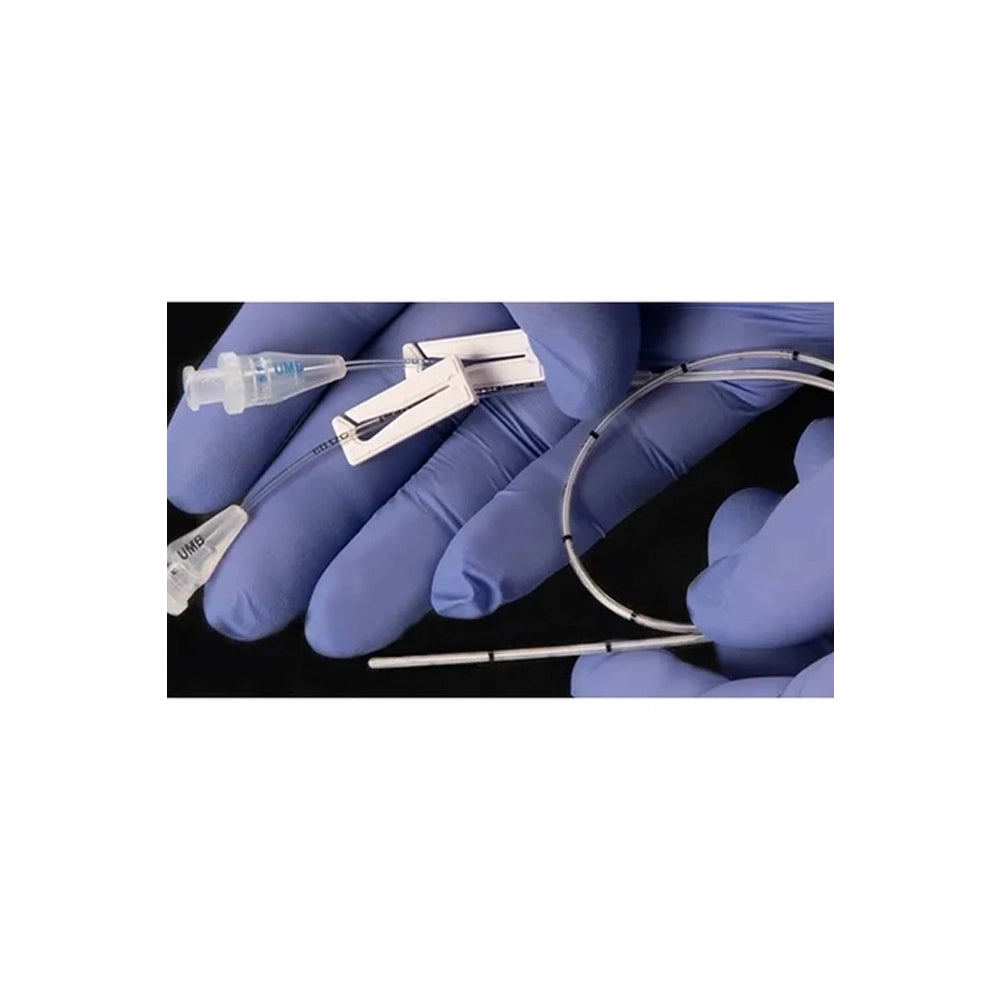 A close-up of gloved hands holding a thin, flexible metallic tube or catheter with attached clear plastic components against a black background.