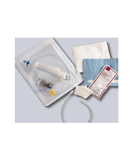 A medical dressing kit containing a clear plastic tray with a syringe, gauze pads, a blue bandage, and a packaged wound dressing, arranged on a light gray background.